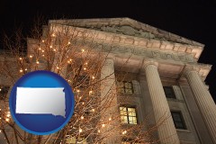 south-dakota map icon and the Internal Revenue Service building in Washington, DC